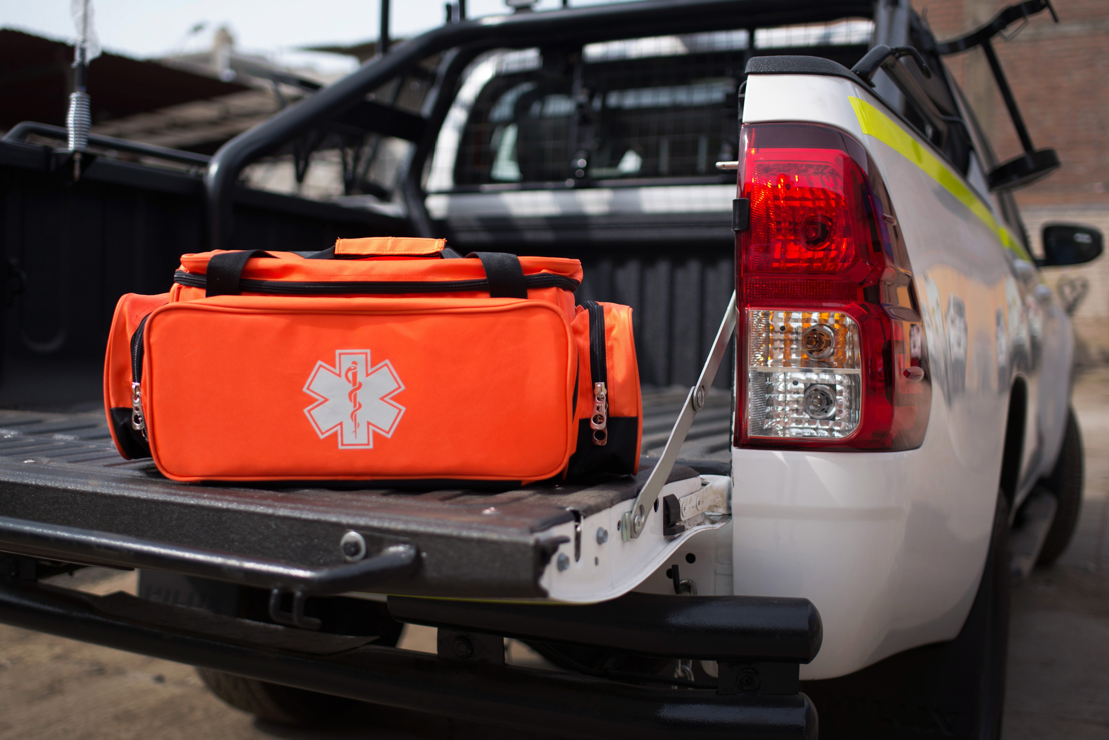 Maletín de emergencia naranja con símbolo médico estrella de la vida